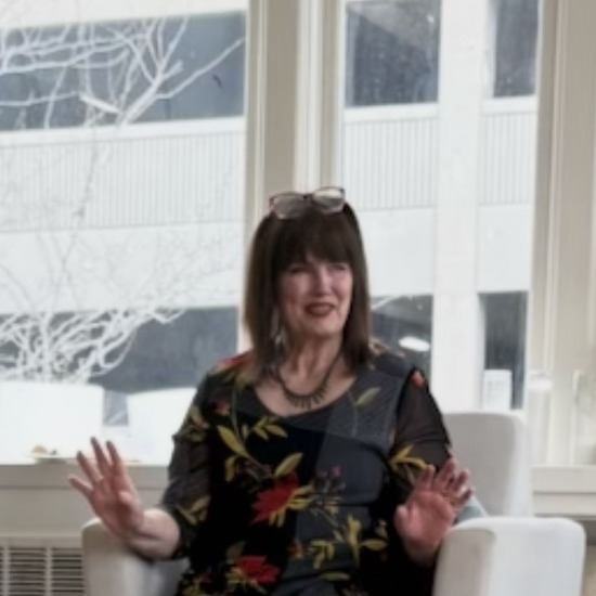 Shelley Sharpe seated by the window